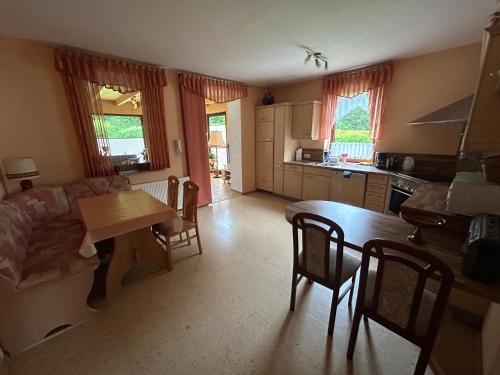 a kitchen and living room with a table and chairs at Gerds Gartenwohnung in Ottrau