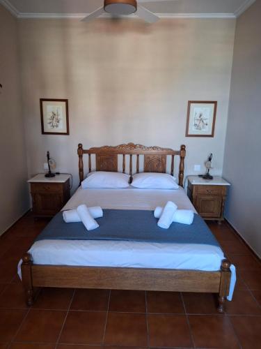 a bedroom with a bed with two night stands at Villa Hydra Estrella in Hydra