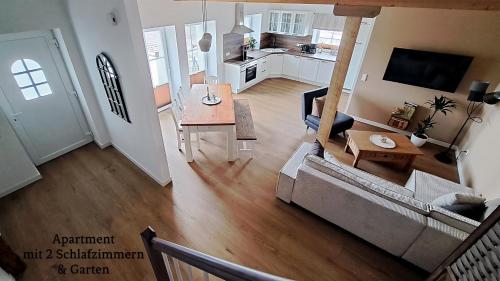 a living room with a couch and a table at Landhaus Seemann Ferienwohnungen im Grünen in Walsrode