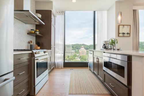 a kitchen with stainless steel appliances and a large window at Panoramic Pack Square | Arras Vacation Rentals in Chalet Village