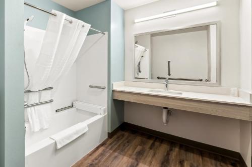 a bathroom with a sink and a mirror at WoodSpring Suites Easton Nazareth in Easton