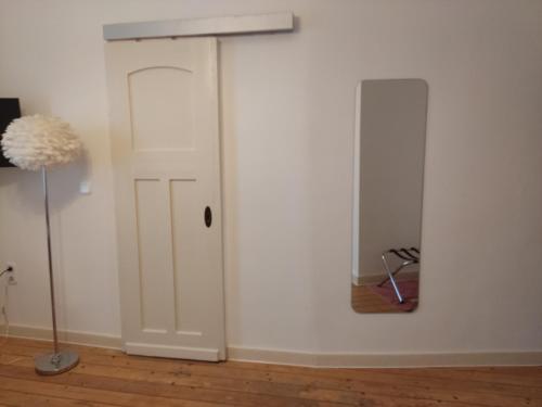 a room with a white door and a lamp at BellaCaro in Löhne