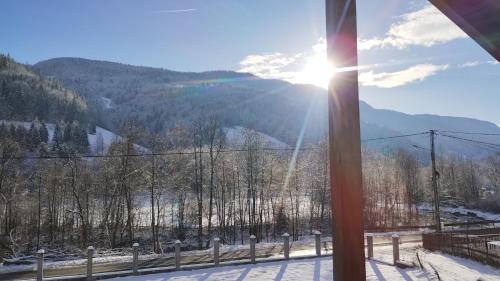 a view of a snow covered mountain from a ski lift at Casa Noastră in Vidra