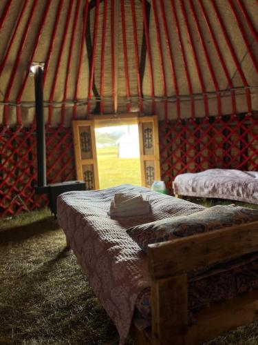 a bedroom with two beds in a yurt at Kel-Suu Kyrgyzstan Yurt Camp in Kol-Suu