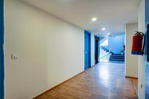 an open hallway with white walls and wood floors at Hotel Aerostar Grand at Yashobhoomi Convention Center in New Delhi