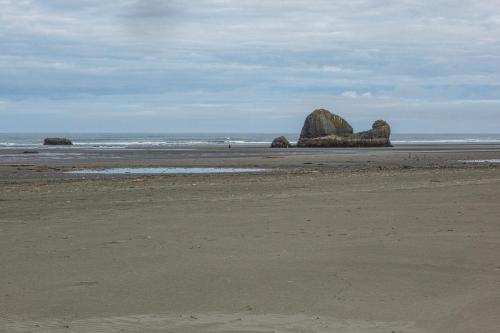a beach with two large rocks in the ocean at Rocks Cabin in Copalis Beach