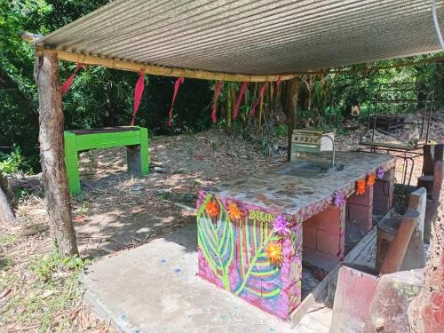 a picnic shelter with a sink and a bench at Cabaña de Lucas in Loma Bonita