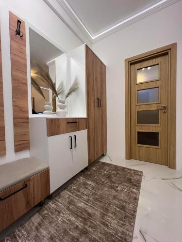 a living room with a door and a rug at Apartman Ruzica in Trebinje