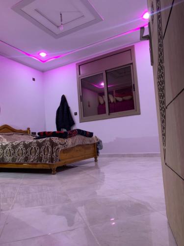 a room with a bed and a mirror on the wall at غرفة الاسطورة in Oujda