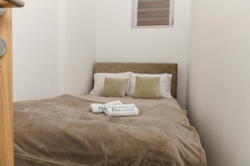 a bed with two pillows on top of it at Apartman Ruzica in Trebinje
