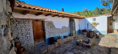 a white brick building with a wooden door at Namaste in Sutatausa
