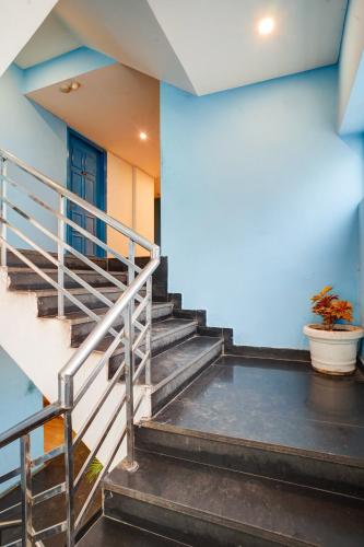 a set of stairs in a building with a blue door at Hotel Aerostar Grand at Yashobhoomi Convention Center in New Delhi