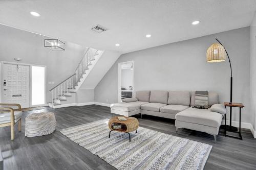 a living room with a couch and a table at Tropical Modern Villa with Pool in Coconut Creek