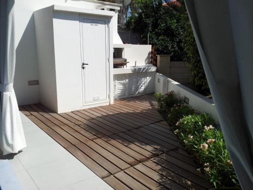 a patio with a white door on a deck at Yialos Holiday Apartments in Pervolia