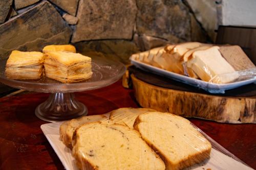 a table topped with slices of bread and sandwiches at Hotel Inkai in Salta