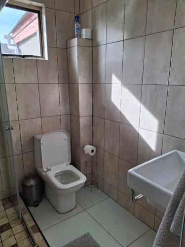 a bathroom with a toilet and a sink at Comfey Stay in Somerset West
