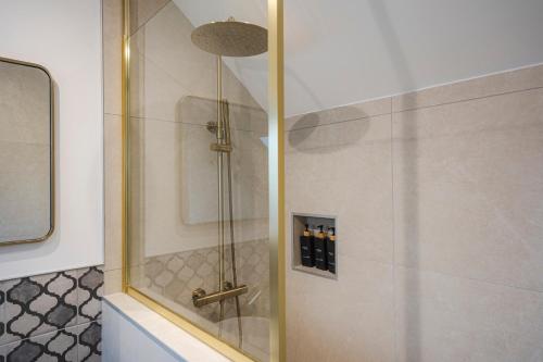 a shower with a glass door in a bathroom at Chambres hote Le Clos 26 in Bellerive-sur-Allier