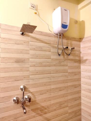 a bathroom with a shower with a water tank at Nomad's Nest Backpackers Hostel in Guwahati