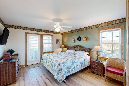 a bedroom with a bed and a ceiling fan at Pamlico Paradise 634 in Waves