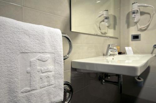 a bathroom with a sink and a towel at Hotel Federico II in Iesi