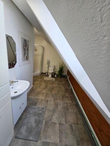 a bathroom with a sink and a toilet at Pension DonauBlick Grein 2 in Stifterstrasse 19A in Grein