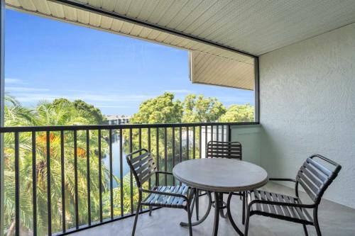 a table and chairs on a balcony with a view at 4th Floor Updated Condo in Naples