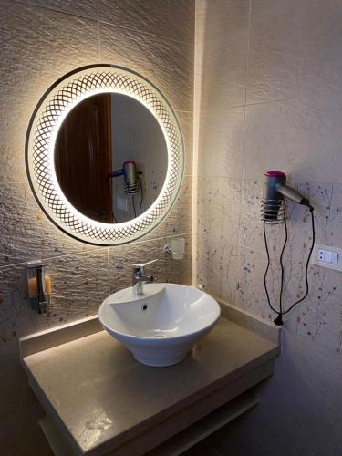 a bathroom with a sink and a mirror at GEM view BOUTIQUE in Cairo
