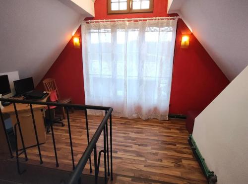 an attic room with a large window and a staircase at Pension DonauBlick Grein 2 in Stifterstrasse 19A in Grein