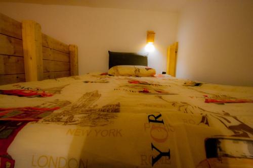 a bedroom with a large bed with a new work blanket at Old Style by the sea, roof terrace with pool and kitchen, Ladispoli in Ladispoli