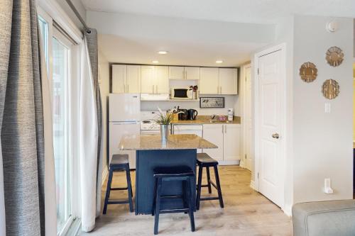 a kitchen with a table and chairs in a room at Condo 807 at North Creek Resort in Blue Mountains