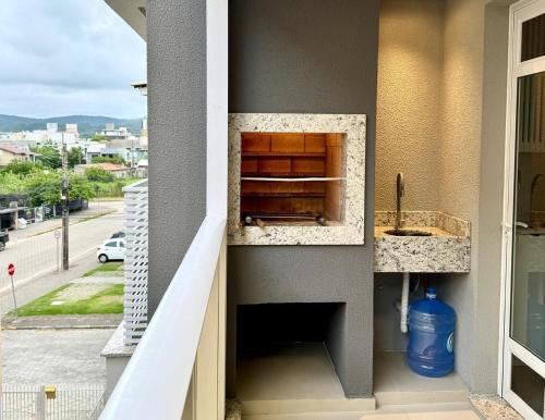 a balcony with a sink and a window at Nassau 203 - Excelente apartamento - Finamente mobiliado e decorado - À poucos metros da praia - (Consultar serviços de roupa de cama e banho) in Bombinhas