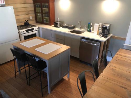 a small kitchen with a table and a sink at Slumberland at the River's Edge in Pond Eddy