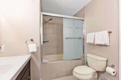 a white bathroom with a toilet and a shower at Pet Friendly Townhouse in Edwards Community in Edwards