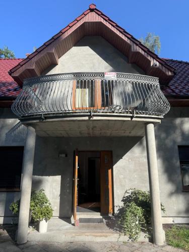 a building with a balcony on top of it at ahoj PRZYLESIE in Pobierowo