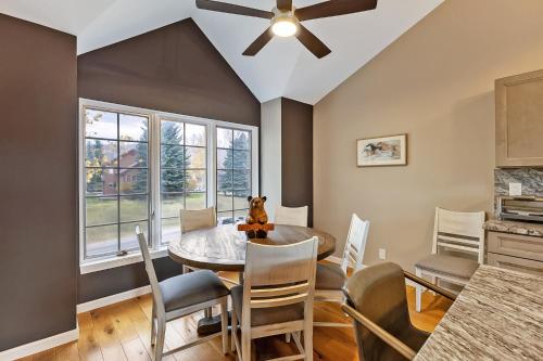 a dining room with a ceiling fan and a table and chairs at Pet Friendly Townhouse in Edwards Community in Edwards