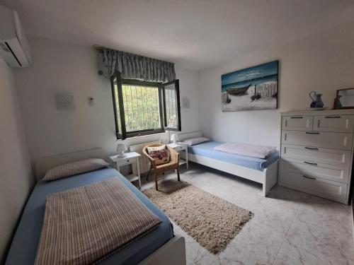 a bedroom with two beds and a dresser at "Traumhaftes Ferienhaus mit Pool und Meerblick - Cumbre del Sol erleben!" in Benitachell