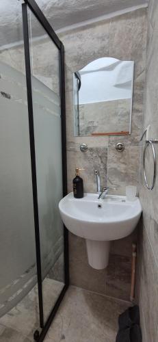 a bathroom with a sink and a mirror at Cappadocia Landscape House in Nevşehir
