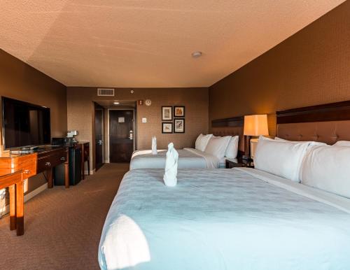a hotel room with two beds and a flat screen tv at Red Deer Resort & Casino in Red Deer