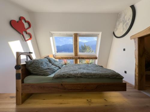 a bed in a room with a window at Cozy Apartment Bovec in Bovec