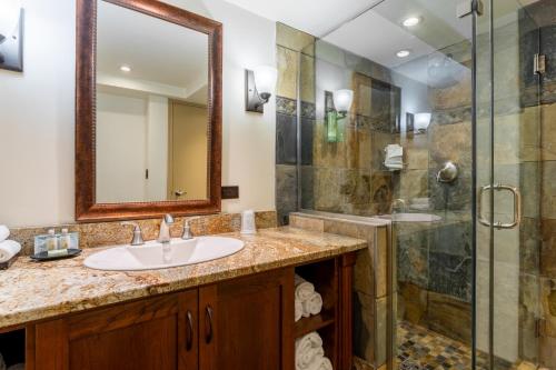 a bathroom with a sink and a shower at Red Deer Resort & Casino in Red Deer