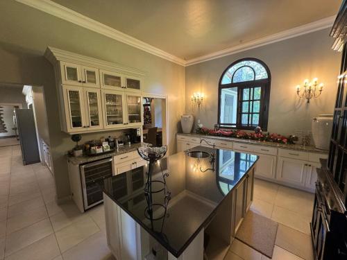 a large kitchen with a counter and a window at Boquete Luxury - Walk to Town in Boquete