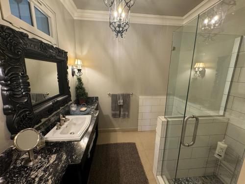 a bathroom with a sink and a glass shower at Boquete Luxury - Walk to Town in Boquete