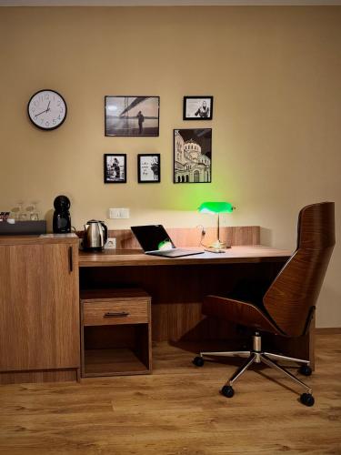 an office with a desk with a laptop and a chair at Apartment Sofia Airport free shuttle and parking in Sofia