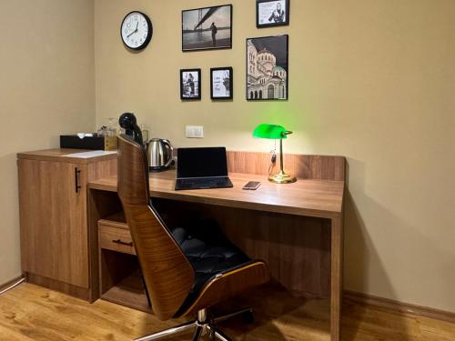 a desk with a laptop computer on top of it at Apartment Sofia Airport free shuttle and parking in Sofia