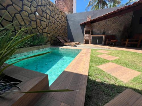 a swimming pool in front of a house at chalé encanto dos milagres in São Miguel dos Milagres