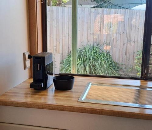 a coffee maker sitting on a counter next to a window at Parklands Cottage in Cowes