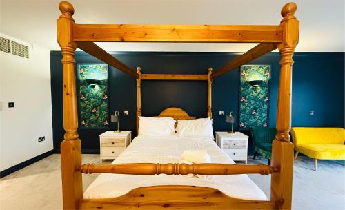 a bedroom with a wooden bed with a wooden frame at Hustyns Hotel in Wadebridge