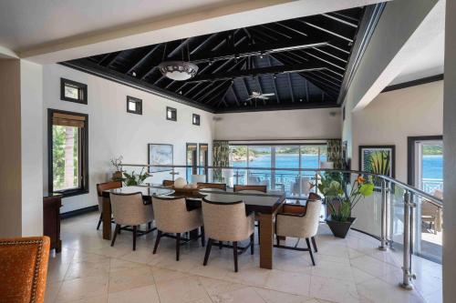 a dining room with a table and chairs at Scrub Island Resort, Spa & Marina in The Mill