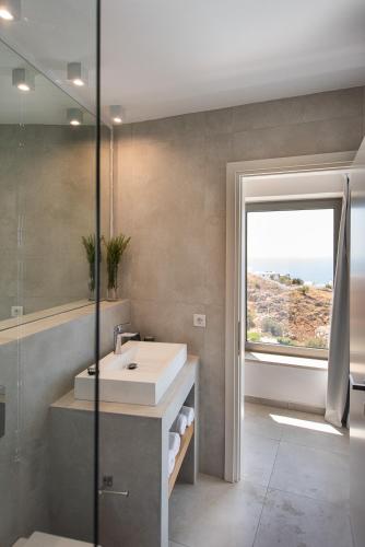 a bathroom with a sink and a window at Villa Dóma in Sfakia