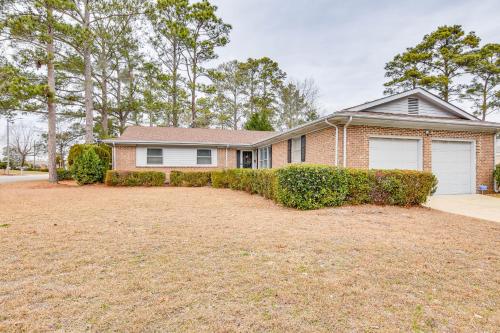 a house with a large yard in front of it at 3 Mi to Dtwn Fayetteville Home with Pool Table in Fayetteville
